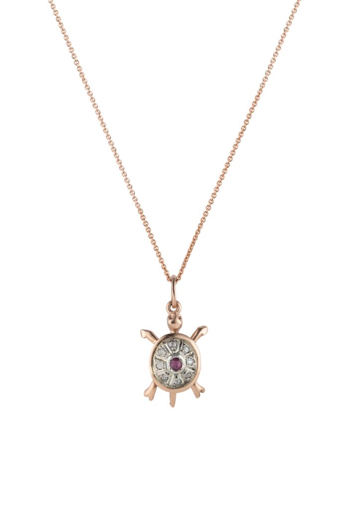 Gold and diamond turtle necklace with ruby on its back