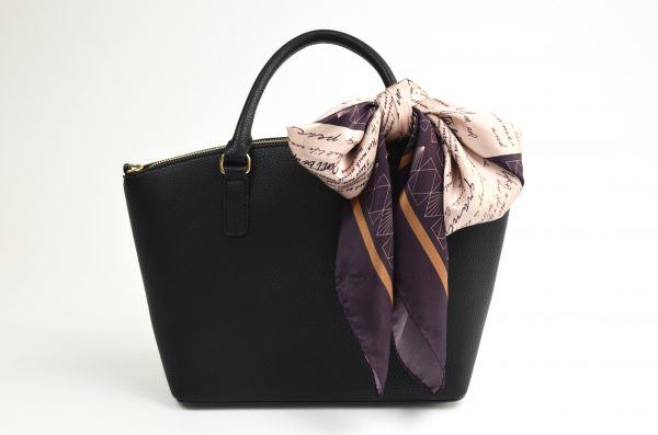 silk scarf tied to bag in a large bow