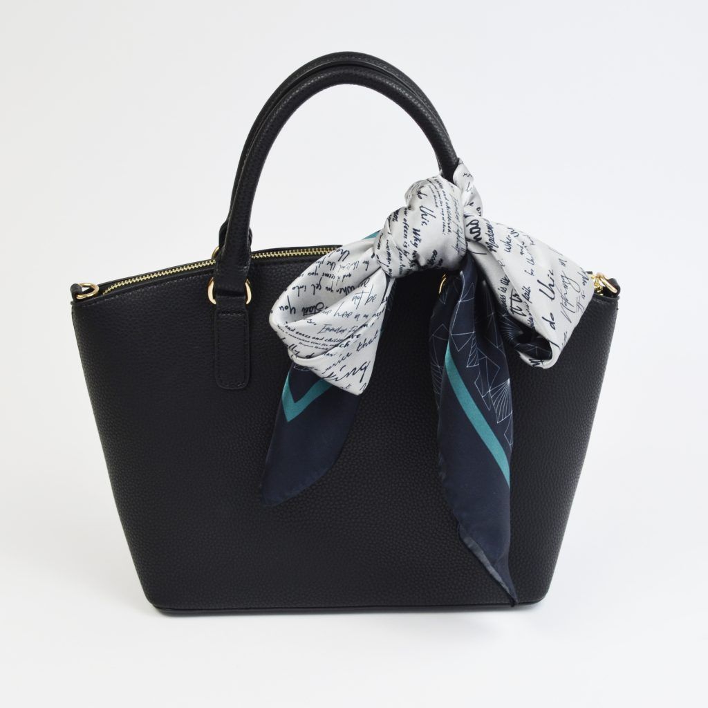 Silk scarf tied to bag handle in bow