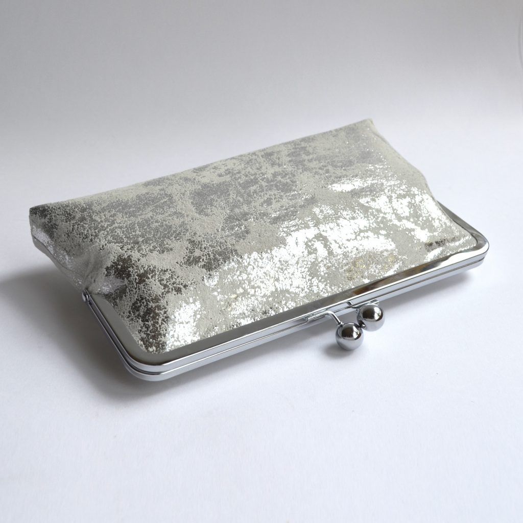 Metallic silver clutch bag with kiss lock closure and vintage kimono lining