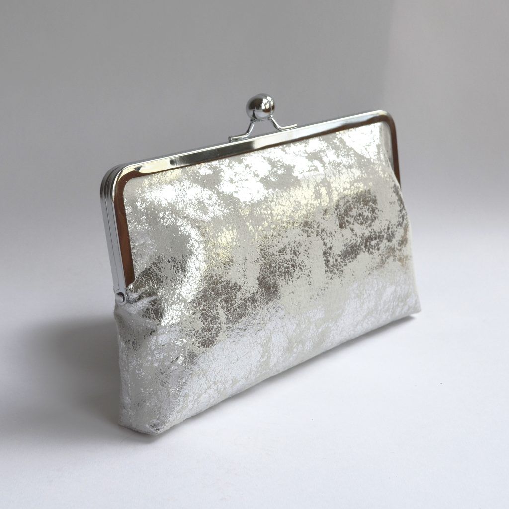 Metallic silver clutch bag with kiss lock closure and vintage kimono lining