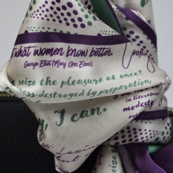 Close up of Silk scarf in Suffragette colours printed with inspiring quotes by women in history