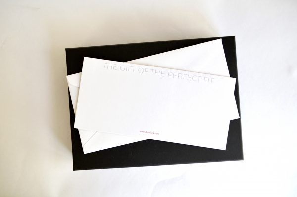 Birdseyeview of Dara Ford gift voucher back with the words The gift of the perfect fit