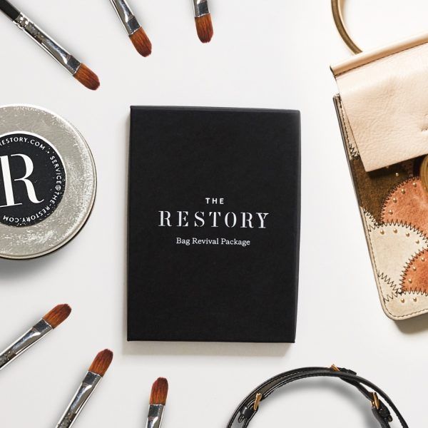 The Restory gift voucher pictured as a flatly surrounded by paint brushes and leather accessories