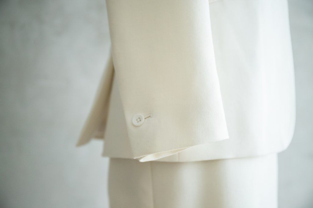 close up of a cream tailored jacket cuff