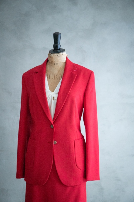 Dressmakers dummy with a red tailored skirt suit and silk ivory camisole