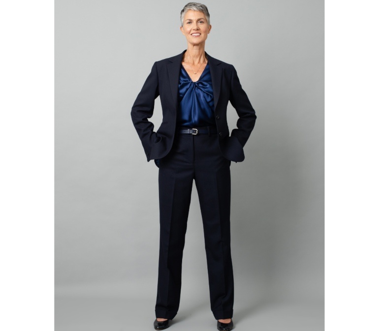White Female model wearing black trouser suit and french silk camisole in midnight blue