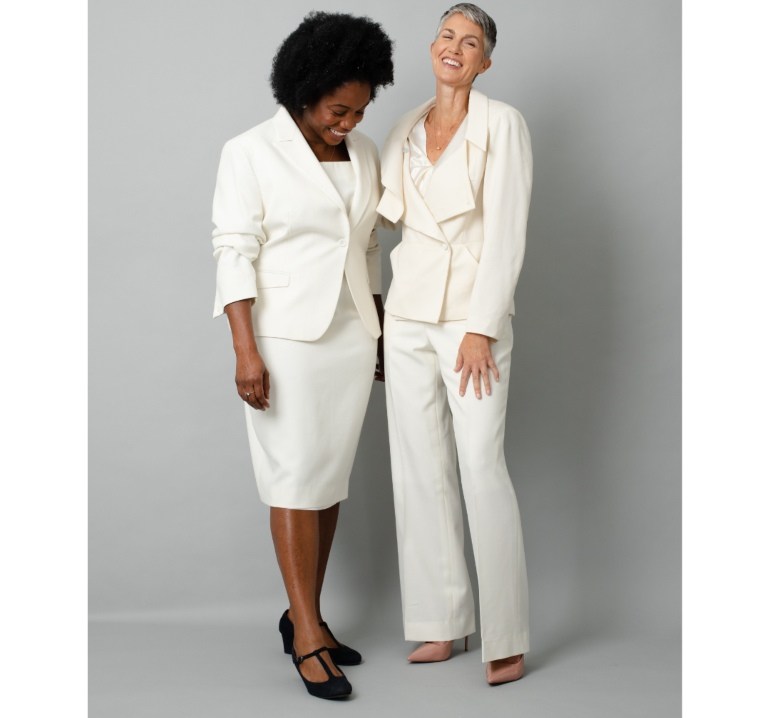 Black model wearing ivory dress suit and white model wearing ivory trouser suit