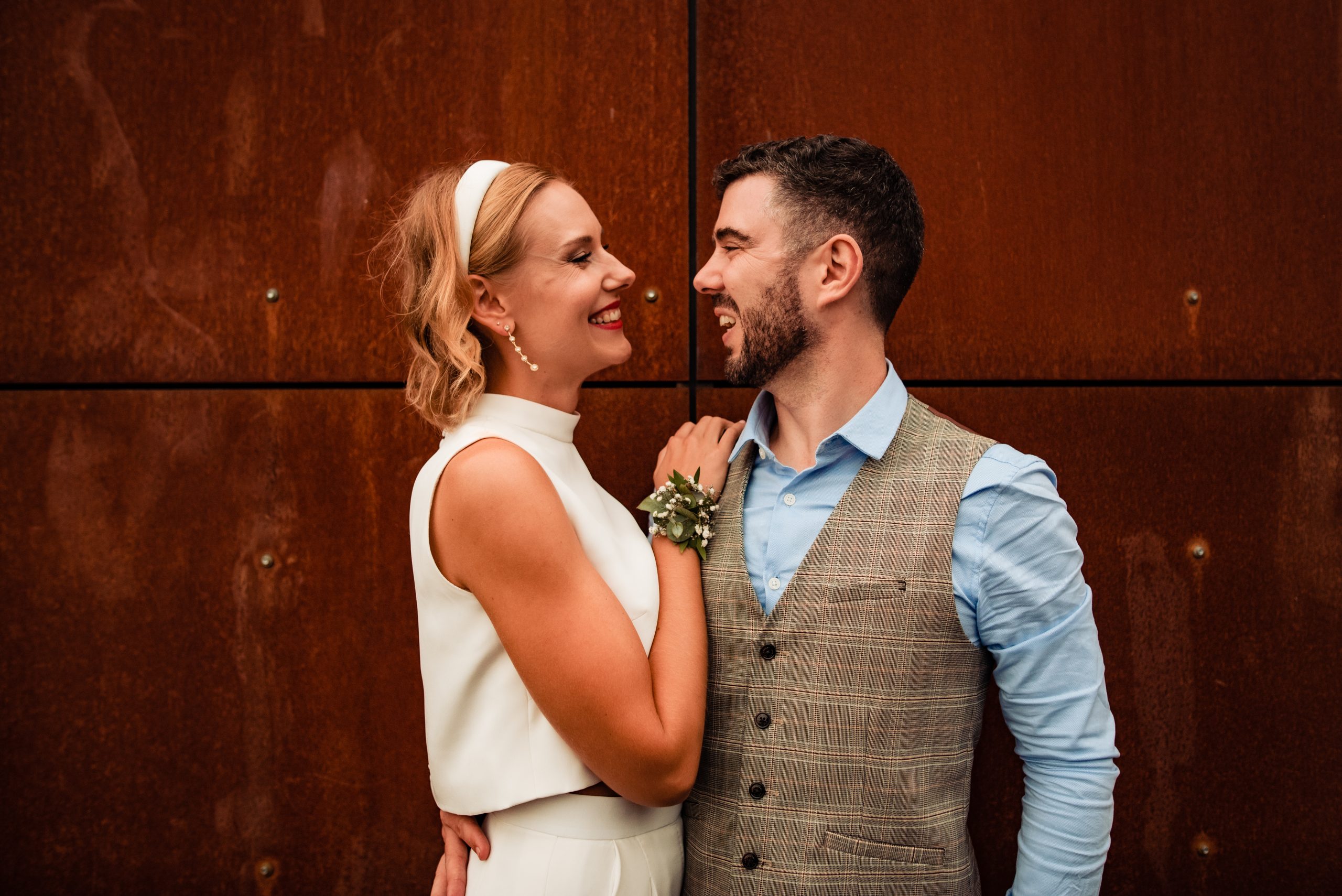 White couple, with Bride wearing ivory silk crop top with groom in waistcoat